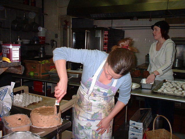 2004 0128KarenFrostingHerPeanutButterCake